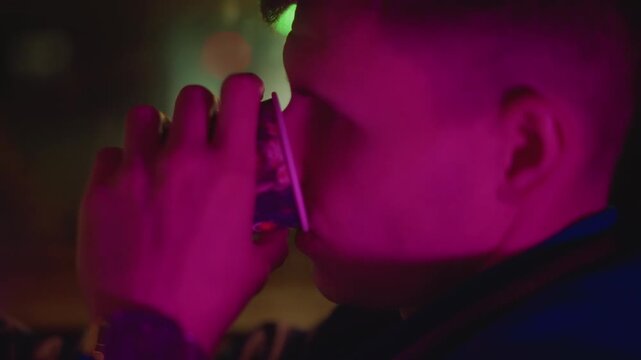caucasian man in neon car profile portrait under magenta light sipping from cup, window reflections and bokeh city backdrop, intimate cinematic atmosphere, driver commuting late with thoughtful