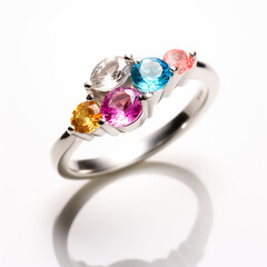 Custom designed birthstone ring with multi colored gemstones on white background