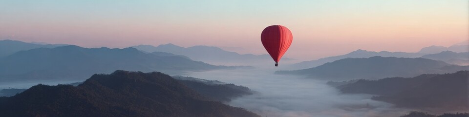 Fototapeta premium Red hot air balloon soaring over misty mountains at sunrise