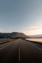 Fototapeta premium Scenic mountain road at sunset along lakeside