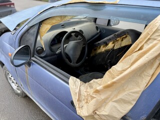 Dusty Steering Wheel And Instrument Cluster Showing Neglected Interior With Heavy Dust Layers, Faded Gauges, Cracked Plastic, Gritty Vents And Stale Atmosphere Hinting Longterm Disuse