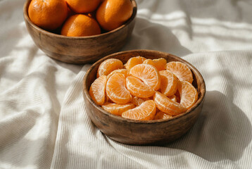 bowl of mandarin oranges basking in sunlight