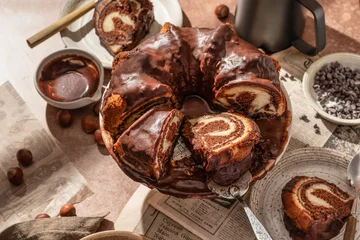 Gardinen Zebra Chocolate marble bundt cake or zebra cake with chocolate glaze sliced on brown table background  © Hanna