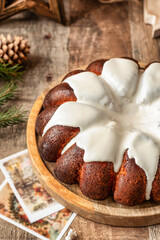 Christmas Gingerbread cake with white sugar glaze on wooden festive rustic background close up