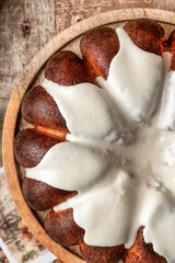 Christmas Gingerbread cake with white sugar glaze on wooden rustic background close up, top view