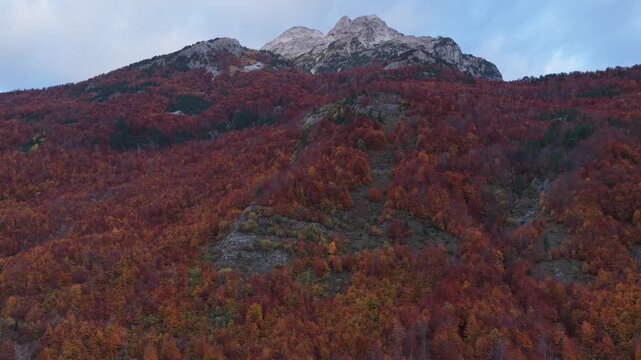 Aerial video of Valbona Valley featuring Jezerca and Maja e That&euml; peaks above autumn forests.