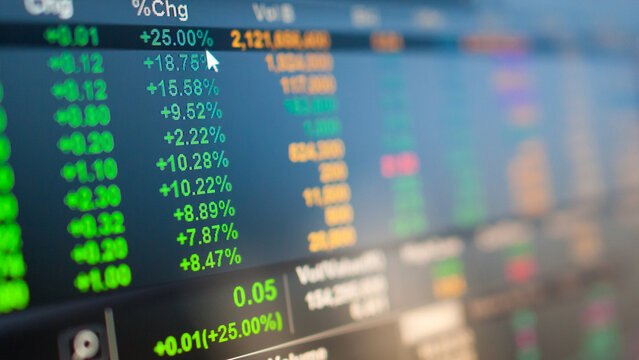 Close-up of a digital screen displaying dynamic stock market data and financial percentage changes, indicating investment trends and business analytics in a modern economic environment. - Powered by Adobe