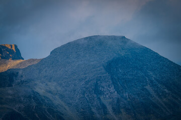 Rocky mountain face illuminated by low sunlight in Rondane
