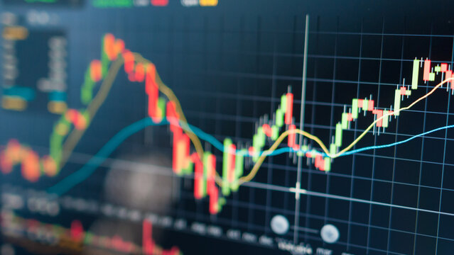 Close-up view of dynamic financial market data displayed on a digital screen, showing fluctuating stock exchange charts and investment trends for business analysis - Powered by Adobe