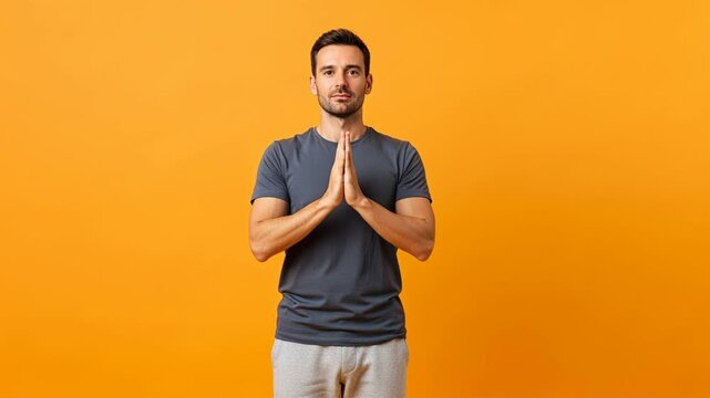 Man performing yoga namaste gesture against orange background in sequence of frames
