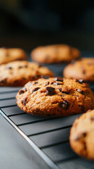 Homemade chocolate chip cookies cooling on a wire rack, showcasing golden brown perfection and rich flavor
