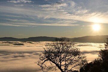 Fototapeta premium Stunning sunrise from a mountain top over the clouds