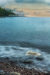 Rock in Swirling Water of Lake Superior with Split Rock Lighthouse in Background