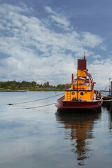 Tugboat Tied to Dock on Still Day