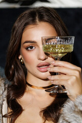 Portrait of stunning gorgeous woman wear black dress enjoying champagne