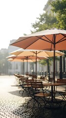 Outdoor cafe with tables and umbrellas on cobblestone street