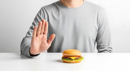 Person Refusing to Eat a Hamburger, Symbolizing Dieting and Healthy Choices.