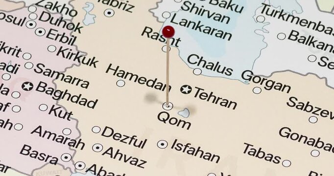 A zoom out of a red pin into Qom city of Iran political map