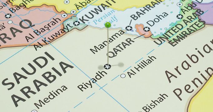 A zoom out of a green pin into riyadh city of Kingdom of Saudi Arabia political map