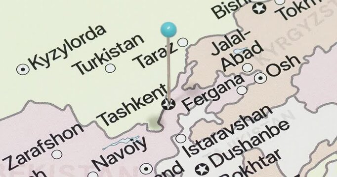 A zoom out of a light blue pin into tashkent city of uzbekistan political map