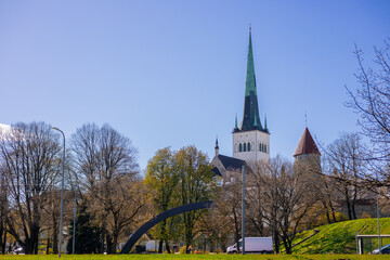 Modern architecture meets history at Tallinn's Old City Harbour. Glass facades reflect the Baltic, while the Gothic St. Olaf s spire anchors the skyline of this evolving maritime hub.