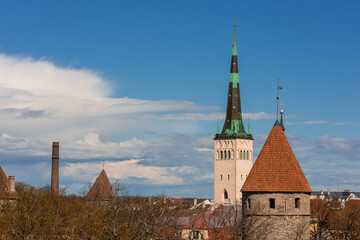 Modern architecture meets history at Tallinn's Old City Harbour. Glass facades reflect the Baltic, while the Gothic St. Olaf s spire anchors the skyline of this evolving maritime hub.