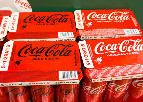 Zagreb, Croatia - December 17, 2025: Coca-Cola beverage packaging featuring original taste and zero sugar variants, stacked together in a vibrant red display, showcasing popular soft drink options