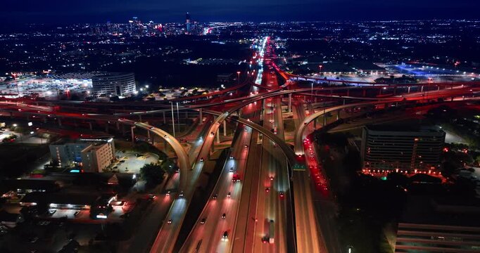 Footage over the lively interchange in the dazzling scenery of a big city. Commuting by the metropolis at night.