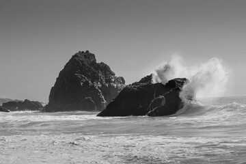 Black and White Waves Crashing on Giant Rocks in the Ocean