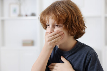 Little boy coughing at home. Cold symptom