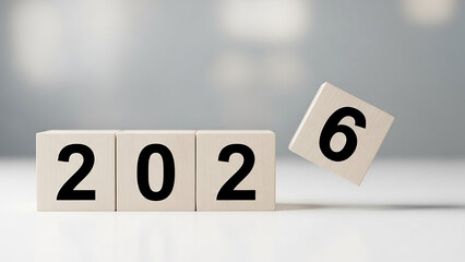 Falling 2026 wooden number block isolated on white background showing change transition risk instability business challenge and future uncertainty concept