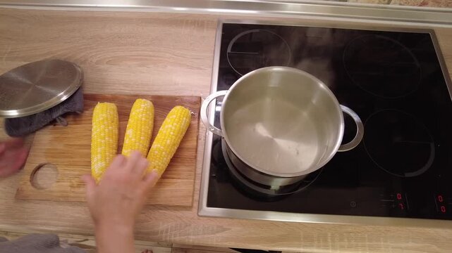 Boiling Fresh Corn on the Stove in a Stylish and Modern Kitchen Space