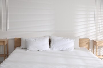Obraz premium Orthopedic mattress and pillows on bed at home, closeup. Space for text