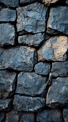 Dark blue stacked stone wall with rustic texture and natural light in vertical composition