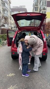 Enjoying a Cozy Car Picnic with Mother and Daughter during Winter Season