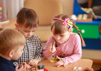 Creative Children Play Together in a Vibrant Learning Environment, Exploring Toys and Expressing Curiosity During a Joyful Afternoon