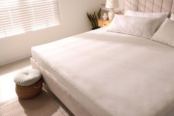 Orthopedic mattress and pillows on bed indoors, closeup