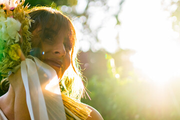 Portrait of a woman with a bridal bouquet at sunset
