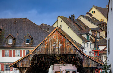 Festive lights on covered wooden bridge, Bremgarten Christmas market Switzerland