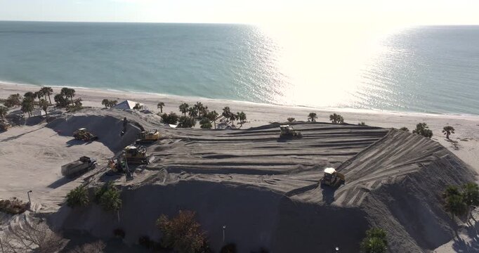 Sand recipient site to dump sand after hurricane Milton storm surge. Huge sand piles at Englewood Beach on Manasota Key. Natural disaster aftermath cleanup.