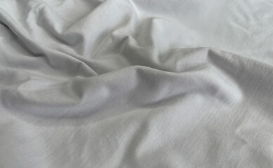  Soft white fabric background with natural flowing folds and gentle look. Minimal natural cotton textile surface. Calm, elegant photo. Luxury branding, fashion mockups, skincare visuals, clean design