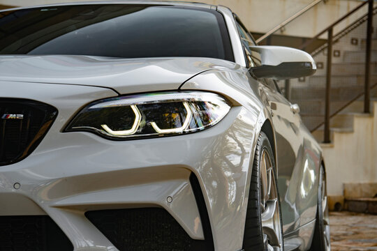 White BMW M2 Competition headlight close up, German sports car led lighting technology