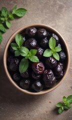 Bowl of prunes with mint garnish in a shallow ceramic bowl,  garnish,  dessert,  wholesome