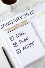 January 2026 new year goal, plan, action, handwritten inspirational checklist text in notebook with coffee cup. Top view. Personal growth, business progress, resolutions, and success concept.