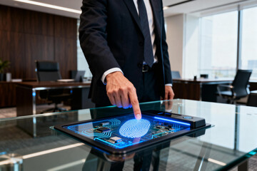 Businessman Using Fingerprint Scanner in Office