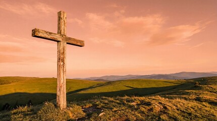 Wooden cross on hillside during sunset with expansive landscape  