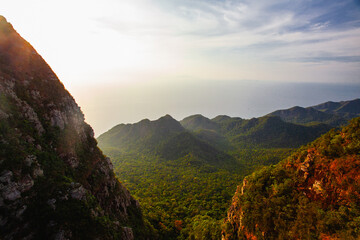 Amazing view from Langkawi's cable car: Majestic Gunung Machincang unfolds below, a tapestry of lush greenery and dramatic cliffs against azure skies. © Alexandra Lande