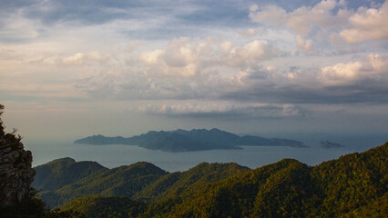 Amazing view from Langkawi's cable car: Majestic Gunung Machincang unfolds below, a tapestry of lush greenery and dramatic cliffs against azure skies. © Alexandra Lande