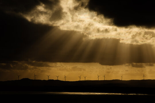 Wind turbines and golden rays and moody clouds