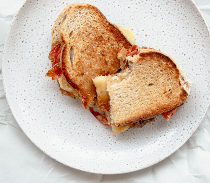 Toasted sandwich in a plate partially eaten